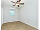 Empty bedroom showcases sleek flooring, a ceiling fan, and natural light from the window, creating a serene space at 3502 N Lincoln Ave, Tampa, FL 33607
