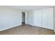 Bedroom featuring vinyl floors, white trim, and ample closet space at 3502 N Lincoln Ave, Tampa, FL 33607