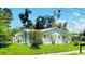Charming single-story home featuring a well-maintained lawn and blooming shrubbery at 3502 N Lincoln Ave, Tampa, FL 33607