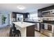 Modern kitchen features stainless steel appliances, white subway tile backsplash, and dark cabinets at 3502 N Lincoln Ave, Tampa, FL 33607