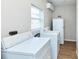Functional laundry area with appliances and natural light from the window at 3502 N Lincoln Ave, Tampa, FL 33607