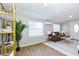 Bright living room features sleek flooring, stylish furniture, and a decorative bookshelf, creating a cozy and inviting atmosphere at 3502 N Lincoln Ave, Tampa, FL 33607