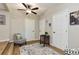 Cozy living room space with neutral walls, wood flooring, a ceiling fan, and multiple doors at 3502 N Lincoln Ave, Tampa, FL 33607