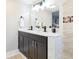 Main bathroom showcasing a double vanity, modern fixtures, and a stylish mirror at 3502 N Lincoln Ave, Tampa, FL 33607