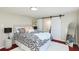 Calm main bedroom features contemporary decor, barn door to ensuite bathroom, and natural light at 3502 N Lincoln Ave, Tampa, FL 33607