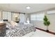 Tranquil bedroom with stylish decor, barn door to ensuite bathroom, and ample natural light at 3502 N Lincoln Ave, Tampa, FL 33607