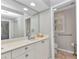 Clean bathroom with double sinks, vanity storage, an expansive mirror, and separate toilet area at 3715 Albacete Cir # 93, Punta Gorda, FL 33950