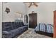 Cozy bedroom with a large couch, neutral carpet, and a wood-paneled ceiling fan at 3715 Albacete Cir # 93, Punta Gorda, FL 33950