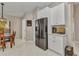 This is a kitchen with white cabinets, stainless steel appliances, a dining table with a chair at 3715 Albacete Cir # 93, Punta Gorda, FL 33950