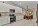 Well-designed kitchen with white cabinetry, tile floors, stainless steel appliances and a cozy eat-in area at 3715 Albacete Cir # 93, Punta Gorda, FL 33950