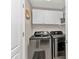 Modern laundry room equipped with front-load washer and dryer and overhead cabinets at 3715 Albacete Cir # 93, Punta Gorda, FL 33950