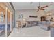 Comfortable living area features tile floors, a large sectional, accent chair, and seamless transition to the outdoor space at 3715 Albacete Cir # 93, Punta Gorda, FL 33950