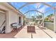Relaxing screened-in patio featuring lounge furniture, a table, and a lush garden view at 3715 Albacete Cir # 93, Punta Gorda, FL 33950