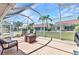 Inviting screened-in patio with comfortable seating and views of the landscaped backyard at 3715 Albacete Cir # 93, Punta Gorda, FL 33950