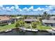 Aerial view of a home featuring a private boat dock and lift, complemented by lush landscaping at 376 Portofino Dr, Punta Gorda, FL 33950