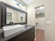 Bathroom features a vessel sink, large mirror, and a walk-in closet at 376 Portofino Dr, Punta Gorda, FL 33950