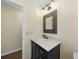 This bathroom has a dark vanity with a marble countertop and unique mirror at 376 Portofino Dr, Punta Gorda, FL 33950