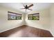 This bedroom features new windows, dark-stained wood-look floors, and a ceiling fan at 376 Portofino Dr, Punta Gorda, FL 33950