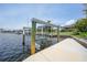 A boat lift sits on a private dock, offering convenience and direct access to the beautiful waterfront at 376 Portofino Dr, Punta Gorda, FL 33950