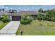 Charming home with well-maintained landscaping, a two-car garage, and a welcoming front lawn at 376 Portofino Dr, Punta Gorda, FL 33950