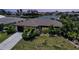 Charming single-story waterfront home with lush landscaping and well-manicured lawn at 376 Portofino Dr, Punta Gorda, FL 33950