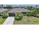 Charming single-story home with a tile roof, lush landscaping, and waterfront views at 376 Portofino Dr, Punta Gorda, FL 33950