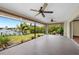 This screened lanai overlooks the canal and yard, with 3 ceiling fans at 376 Portofino Dr, Punta Gorda, FL 33950
