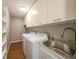 This laundry room features a utility sink, washer, dryer, and cabinetry at 376 Portofino Dr, Punta Gorda, FL 33950