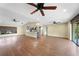 Open-concept living space with wood floors, ceiling fans, and a kitchen island for entertaining at 376 Portofino Dr, Punta Gorda, FL 33950