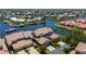 Aerial view of waterfront homes with canals and boat docks on a sunny day at 3800 Bal Harbor Blvd # 415, Punta Gorda, FL 33950