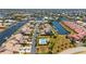 Aerial view of a waterfront community with canals, boat docks, and a community pool at 3800 Bal Harbor Blvd # 415, Punta Gorda, FL 33950