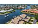 Aerial view of a waterfront community with canals, boats, and houses with tile roofs at 3800 Bal Harbor Blvd # 415, Punta Gorda, FL 33950