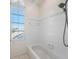 Clean and bright bathroom featuring a shower-tub combo with white tile at 3800 Bal Harbor Blvd # 415, Punta Gorda, FL 33950