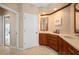 Bright bathroom with white door and wood cabinets, white countertops and tile flooring at 3800 Bal Harbor Blvd # 415, Punta Gorda, FL 33950