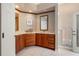 Bright bathroom featuring dual sinks with wood cabinets, white countertops and tile flooring at 3800 Bal Harbor Blvd # 415, Punta Gorda, FL 33950