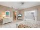 Bedroom with white walls, tile floor, access to patio and ensuite bathroom at 3800 Bal Harbor Blvd # 415, Punta Gorda, FL 33950