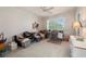 Spacious bedroom with a large window and carpeted floor, furnished with a desk and drawer unit at 3800 Bal Harbor Blvd # 415, Punta Gorda, FL 33950