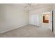 Large bedroom with carpet flooring, a closet, and a view into the hallway at 3800 Bal Harbor Blvd # 415, Punta Gorda, FL 33950