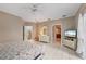 Spacious bedroom with tiled floors, complemented by a dresser and staircase access at 3800 Bal Harbor Blvd # 415, Punta Gorda, FL 33950