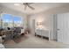 Bedroom with bright window, ceiling fan, and carpeted floor; includes a desk and drawer unit at 3800 Bal Harbor Blvd # 415, Punta Gorda, FL 33950