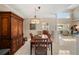 Elegant dining room with chandelier, wood table, and views into living area at 3800 Bal Harbor Blvd # 415, Punta Gorda, FL 33950