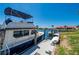 Boat docked on private pier in a waterfront community with lush grass and clear, blue skies at 3800 Bal Harbor Blvd # 415, Punta Gorda, FL 33950