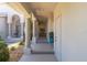 Inviting front porch with decorative columns, mature landscaping, and bench seating at 3800 Bal Harbor Blvd # 415, Punta Gorda, FL 33950