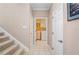 Hallway leading to the laundry room, featuring neutral tones and tile flooring at 3800 Bal Harbor Blvd # 415, Punta Gorda, FL 33950