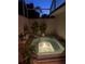 Private outdoor spa surrounded by plants in a covered patio area at 3800 Bal Harbor Blvd # 415, Punta Gorda, FL 33950