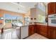 Bright kitchen with wood cabinets, granite countertops, and breakfast nook with waterfront views at 3800 Bal Harbor Blvd # 415, Punta Gorda, FL 33950