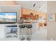 Open-concept kitchen and bar area with modern appliances and comfortable seating at 3800 Bal Harbor Blvd # 415, Punta Gorda, FL 33950
