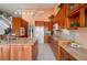 Bright kitchen with wooden cabinets, granite countertops, and stainless steel appliances at 3800 Bal Harbor Blvd # 415, Punta Gorda, FL 33950
