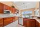 Spacious kitchen with wooden cabinets, granite countertops, and water view at 3800 Bal Harbor Blvd # 415, Punta Gorda, FL 33950