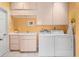 Bright laundry room with a sink, countertop, storage, and washer and dryer at 3800 Bal Harbor Blvd # 415, Punta Gorda, FL 33950